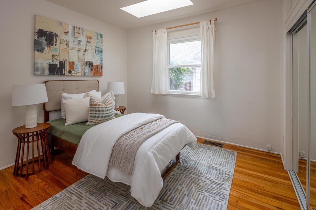 5416 Taft Avenue La Jolla, CA 92037 - Photo 14 of 23 a bedroom with bed and wooden floor