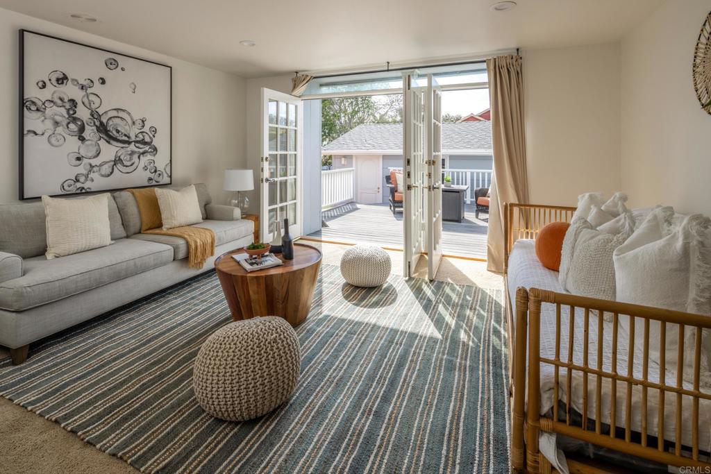 5416 Taft Avenue La Jolla, CA 92037 - Photo 17 of 23 a living room with furniture a lamp and a potted plant