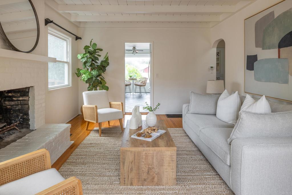 5416 Taft Avenue La Jolla, CA 92037 - Photo 4 of 23 a living room with furniture a rug a lamp and a fireplace