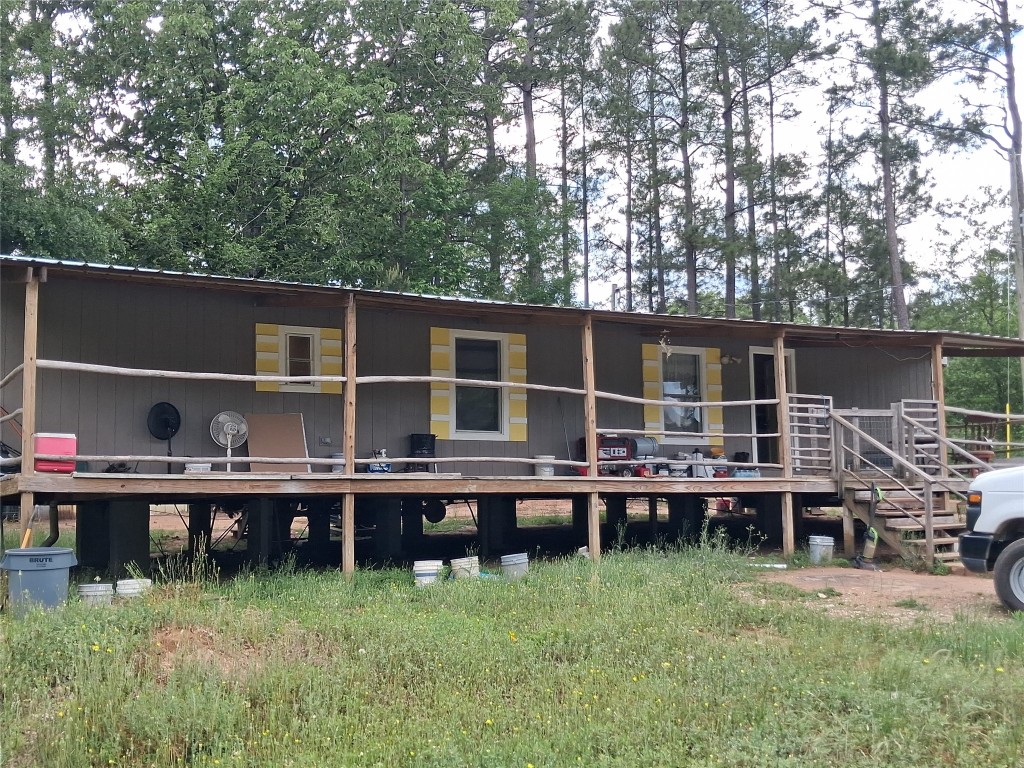3646 Upper Leggett Road Livingston, TX 77351 - Photo 4 of 43 a view of a backyard with wooden fence and large trees