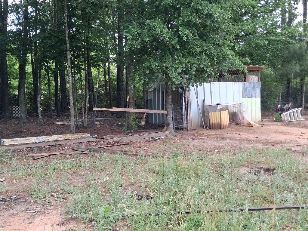 3646 Upper Leggett Road Livingston, TX 77351 - Photo 9 of 43 a backyard of a house with table and chairs