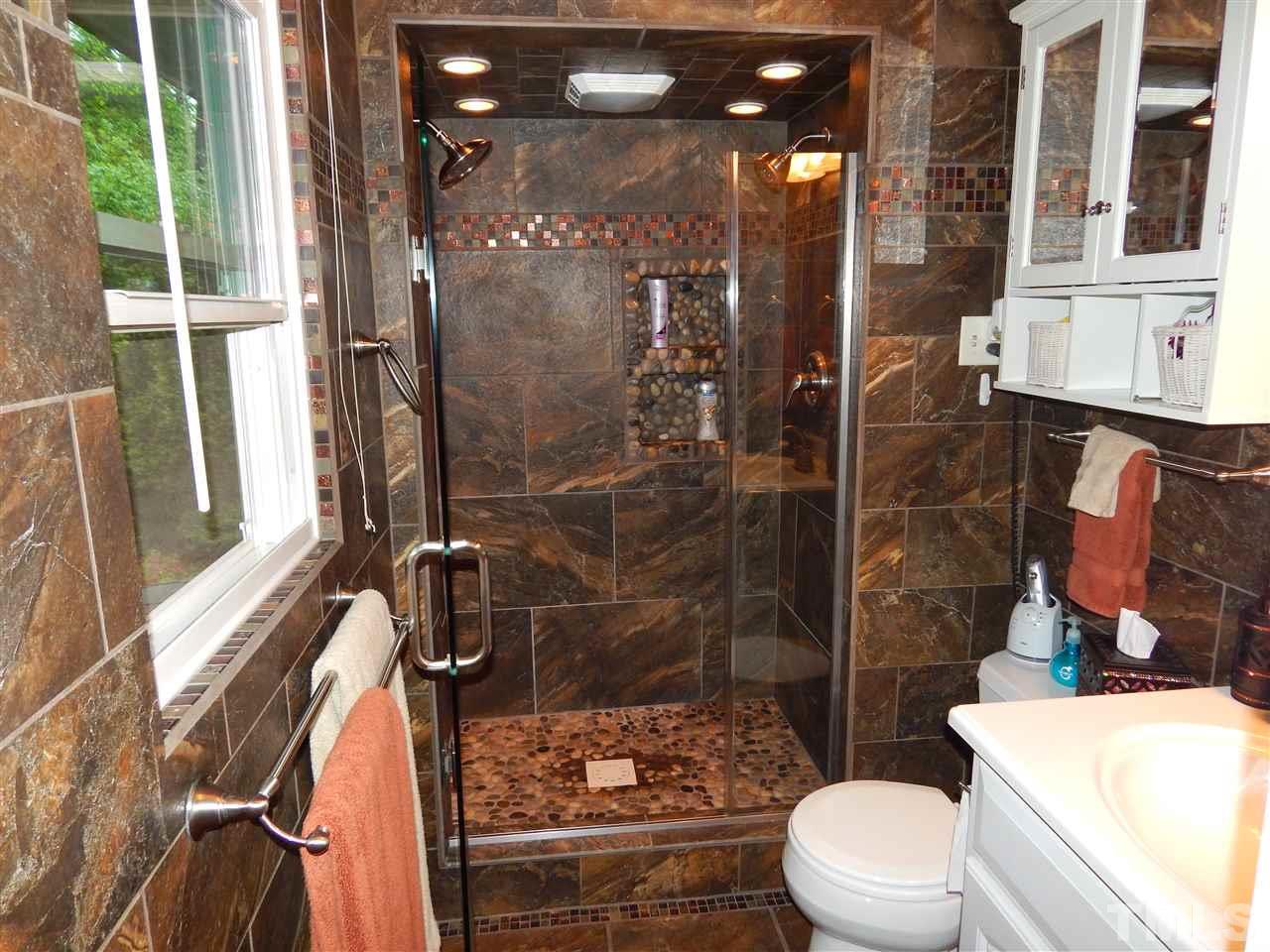 5304 Edgewood Road Raleigh, NC 27609 - Photo 12 of 25 a bathroom with a toilet and a shower