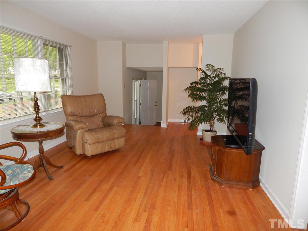 5304 Edgewood Road Raleigh, NC 27609 - Photo 16 of 25 a living room with furniture and a wooden floor