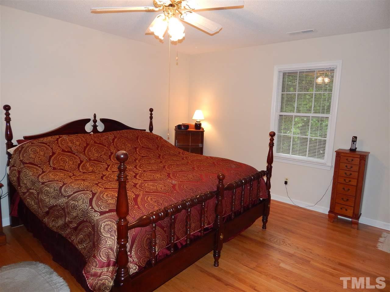 5304 Edgewood Road Raleigh, NC 27609 - Photo 18 of 25 a bedroom with a bed and a chair
