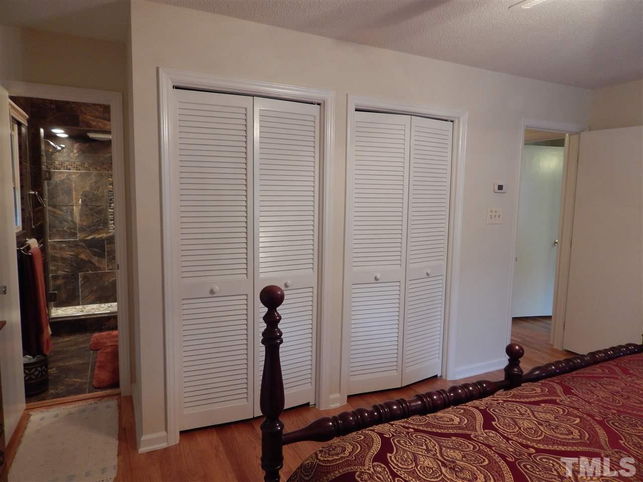 5304 Edgewood Road Raleigh, NC 27609 - Photo 19 of 25 a bedroom with a bed and a walk in closet