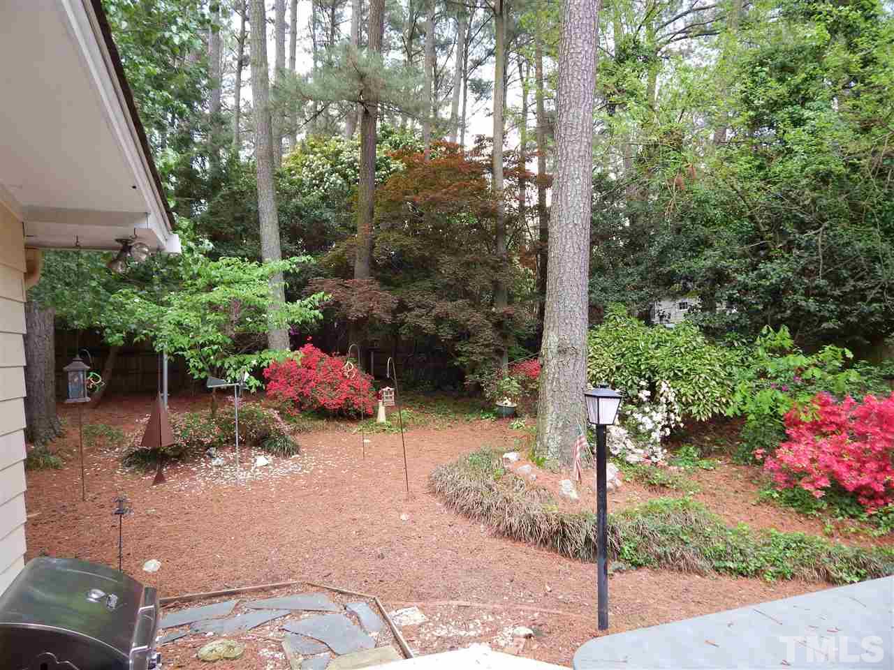 5304 Edgewood Road Raleigh, NC 27609 - Photo 3 of 25 a backyard of a house with a yard and outdoor seating