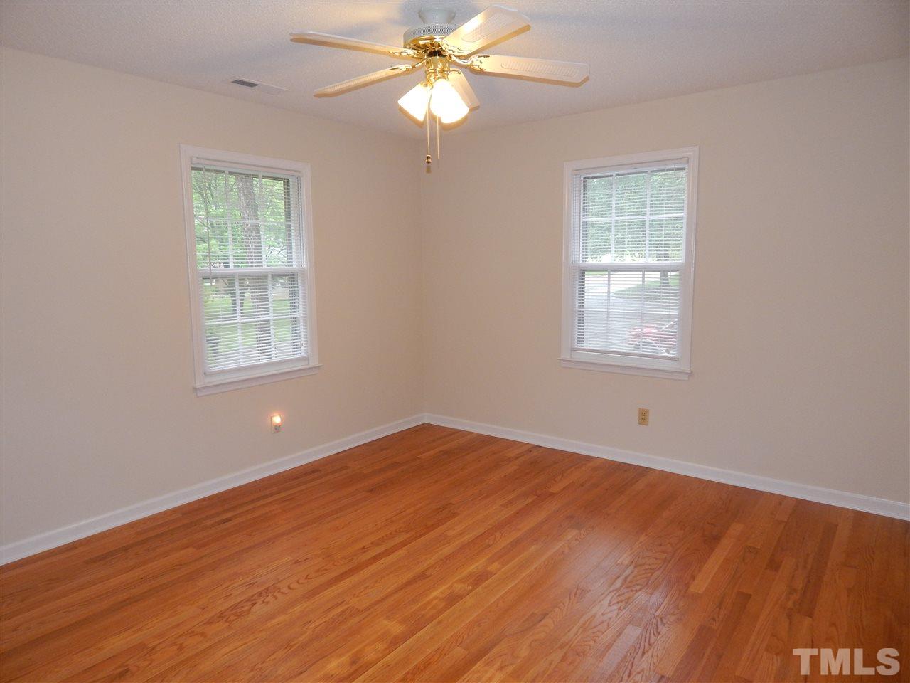 5304 Edgewood Road Raleigh, NC 27609 - Photo 24 of 25 wooden floor in an empty room with a window