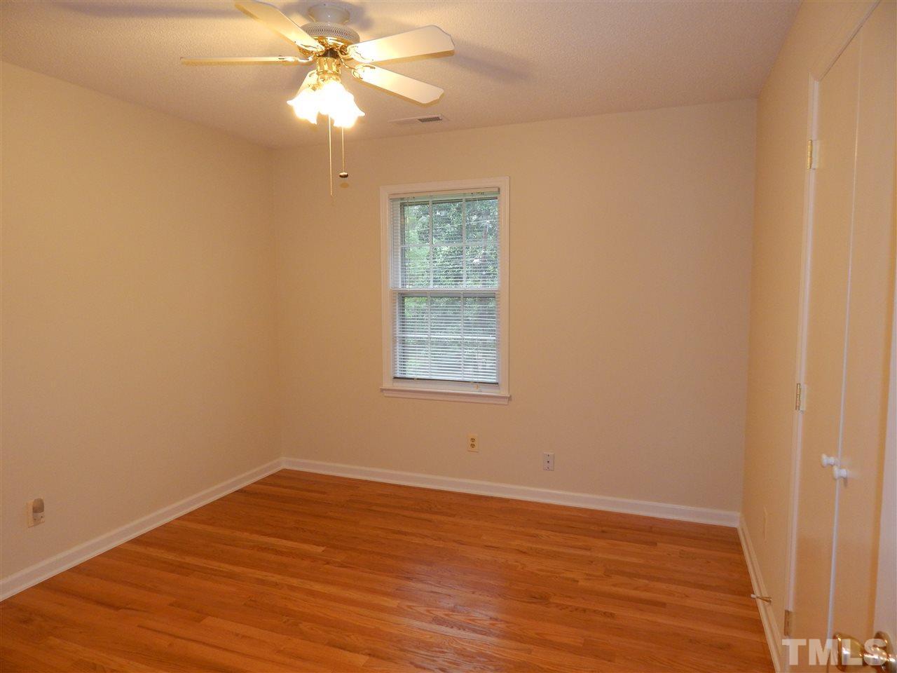 5304 Edgewood Road Raleigh, NC 27609 - Photo 25 of 25 a view of an empty room with wooden floor and a window
