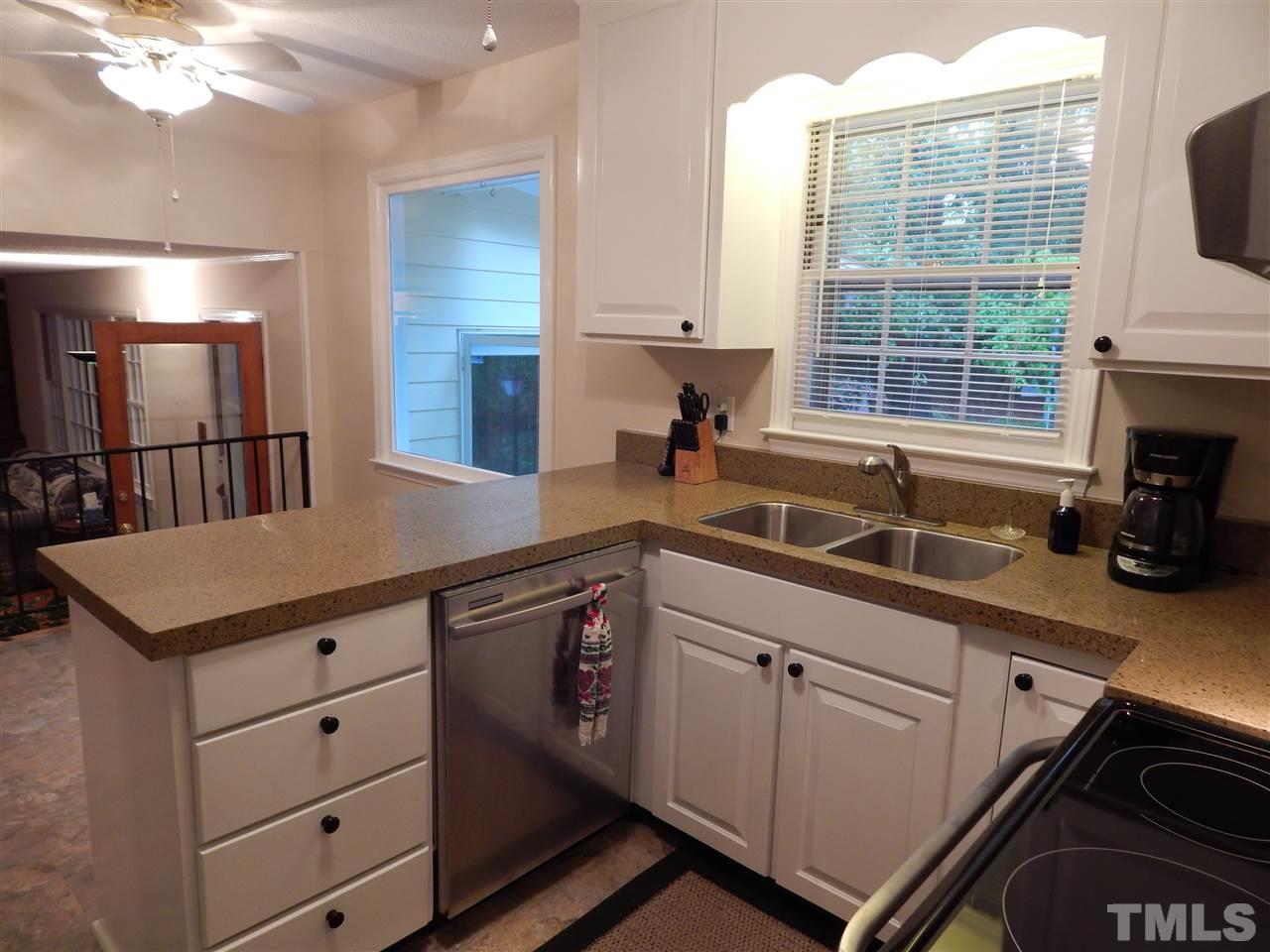 5304 Edgewood Road Raleigh, NC 27609 - Photo 6 of 25 a kitchen with a stove a sink and a cabinets