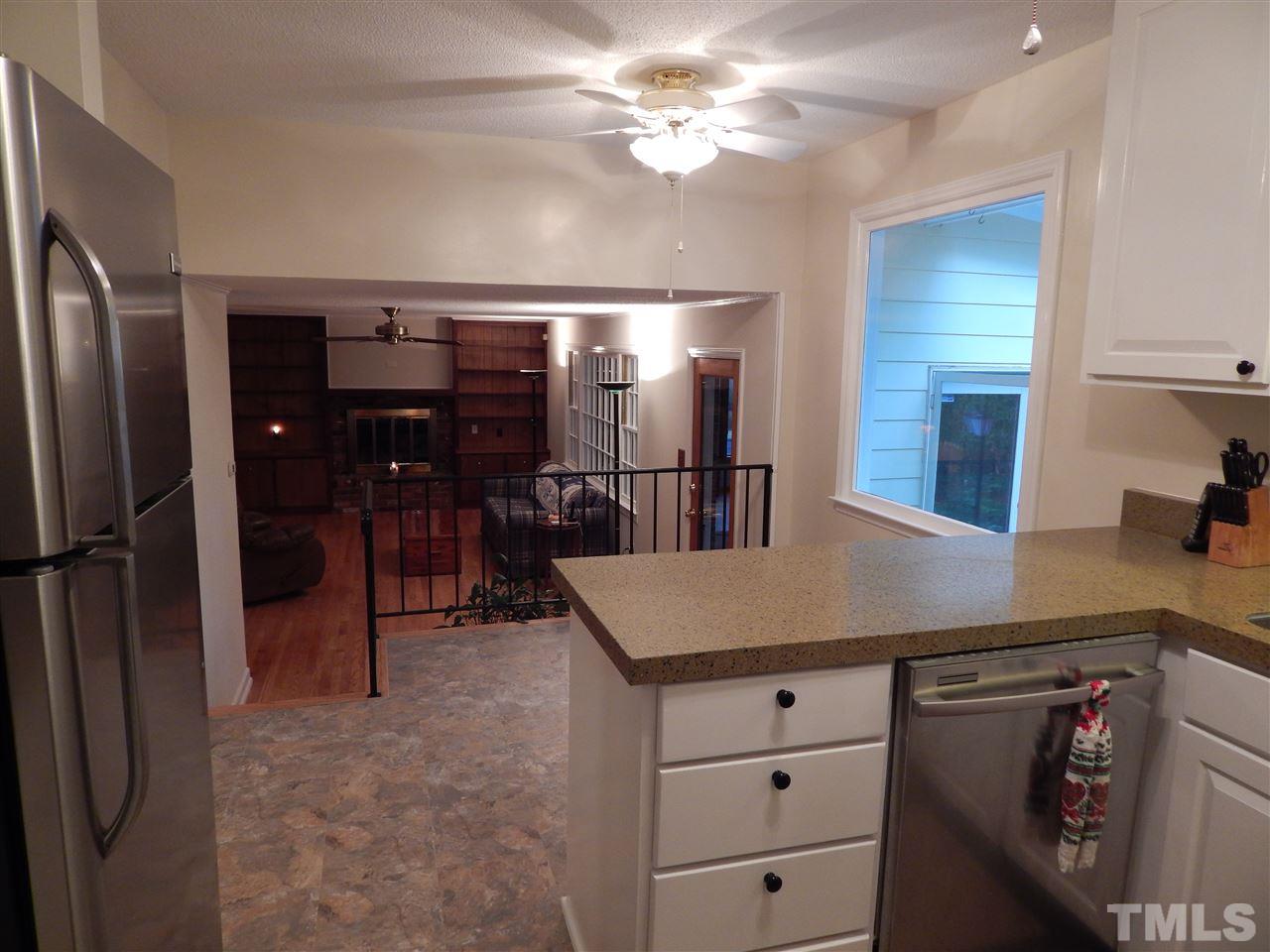 5304 Edgewood Road Raleigh, NC 27609 - Photo 8 of 25 a kitchen with cabinets and stainless steel appliances