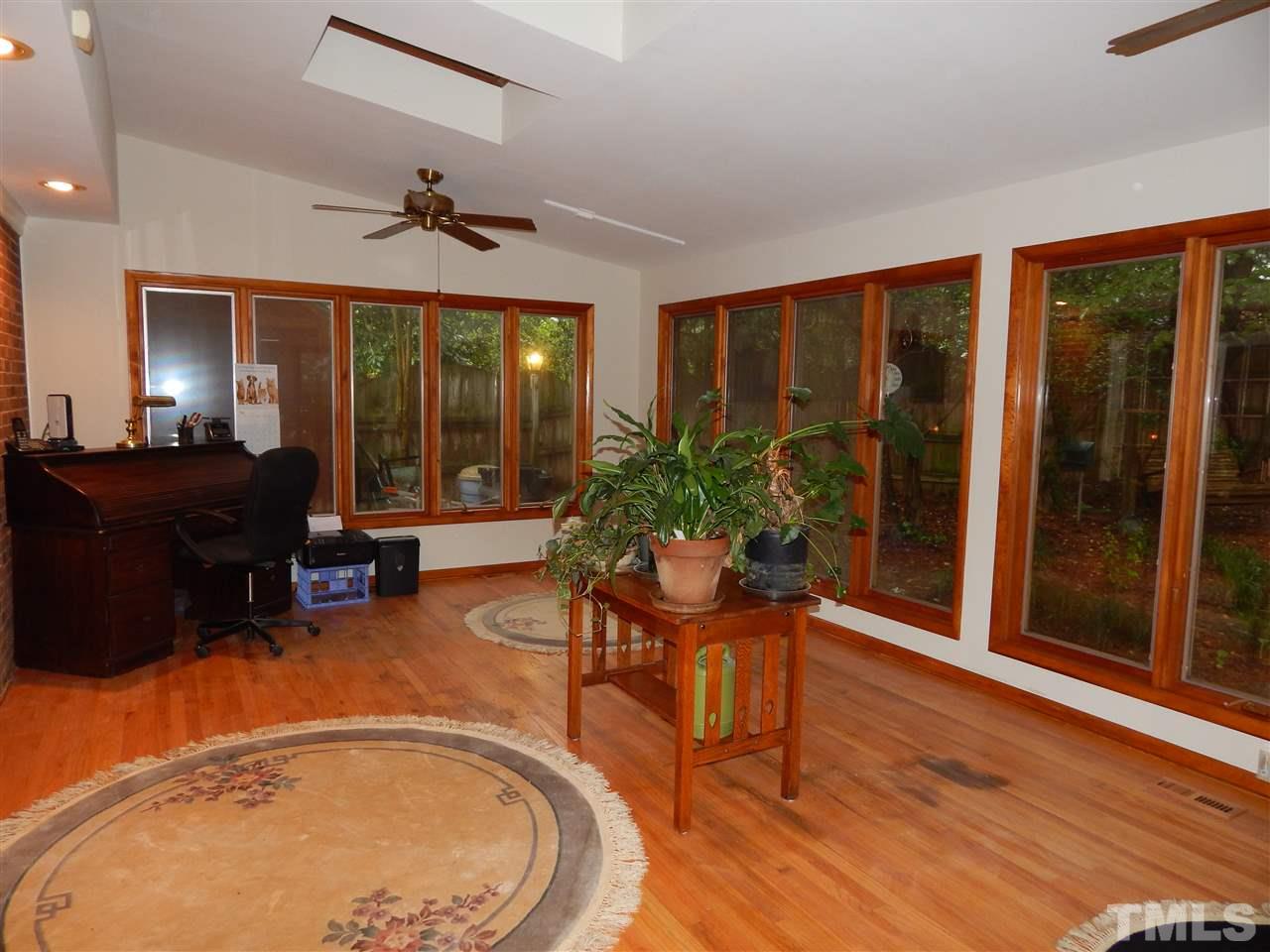 5304 Edgewood Road Raleigh, NC 27609 - Photo 9 of 25 a living room with furniture and large windows
