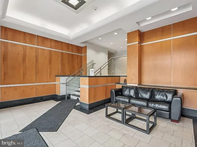 a living room with a table and a potted plant