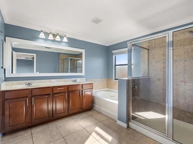 a bathroom with a tub shower and sink