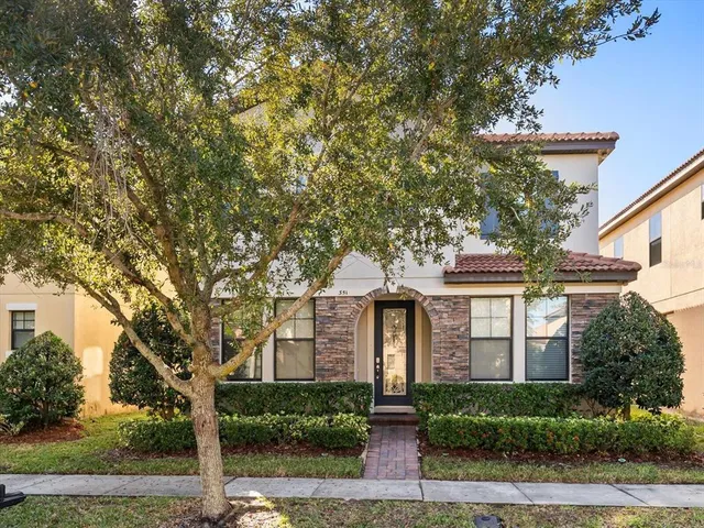 front view of a house with a tree