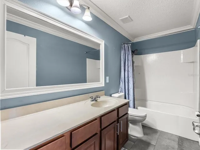 a bathroom with a sink a toilet a mirror and bathtub