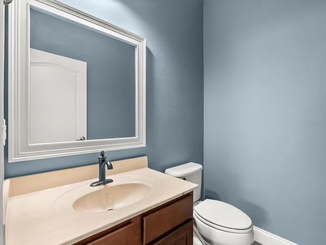 a bathroom with a sink a toilet and mirror