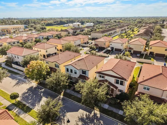 an aerial view of residential houses with outdoor space
