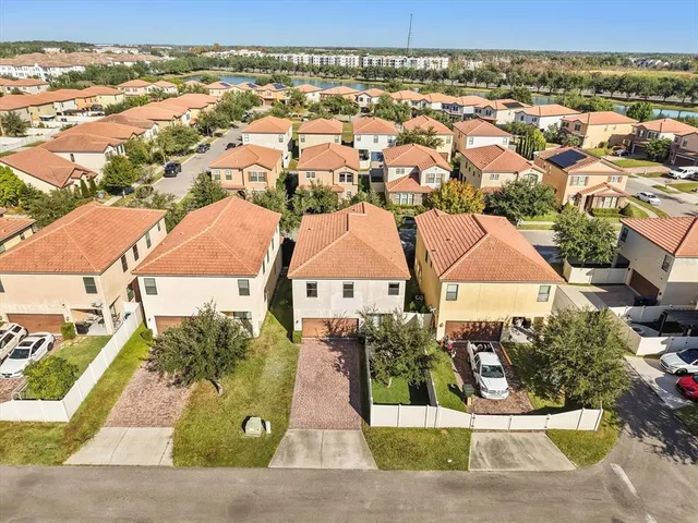 an aerial view of residential houses with outdoor space