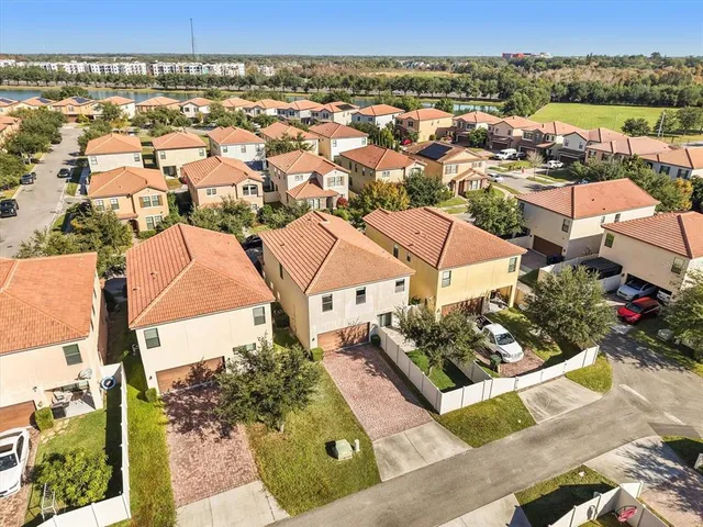 an aerial view of a house with a yard