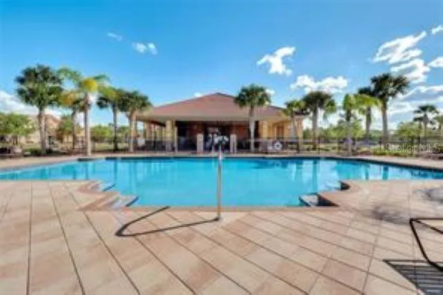 a view of a swimming pool with a patio