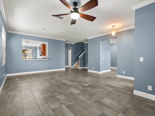 a view of an empty room with a ceiling fan