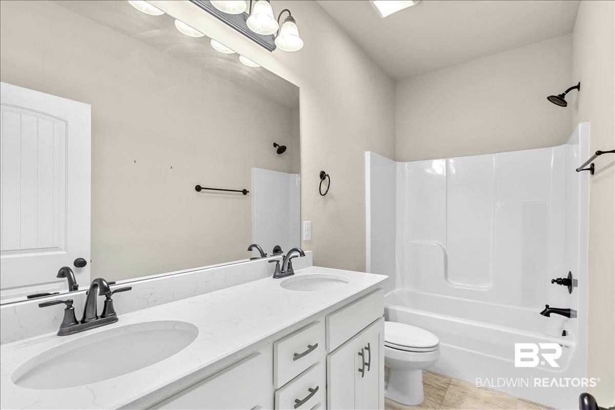 1112 Stella Road Foley, AL 36535 - Photo 19 of 33 Bathroom featuring double vanity and bathtub / shower combination