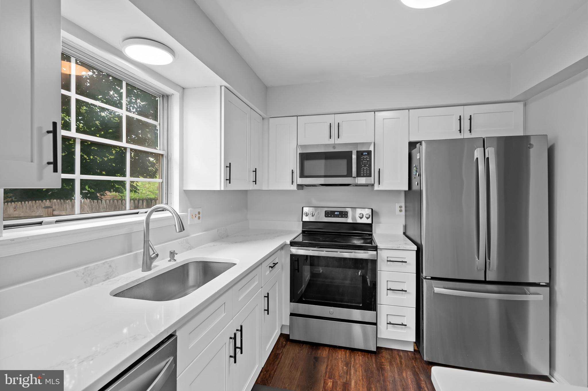 4511 Jenner Court Olney, MD 20832 - Photo 13 of 40 a kitchen with appliances a sink and a window
