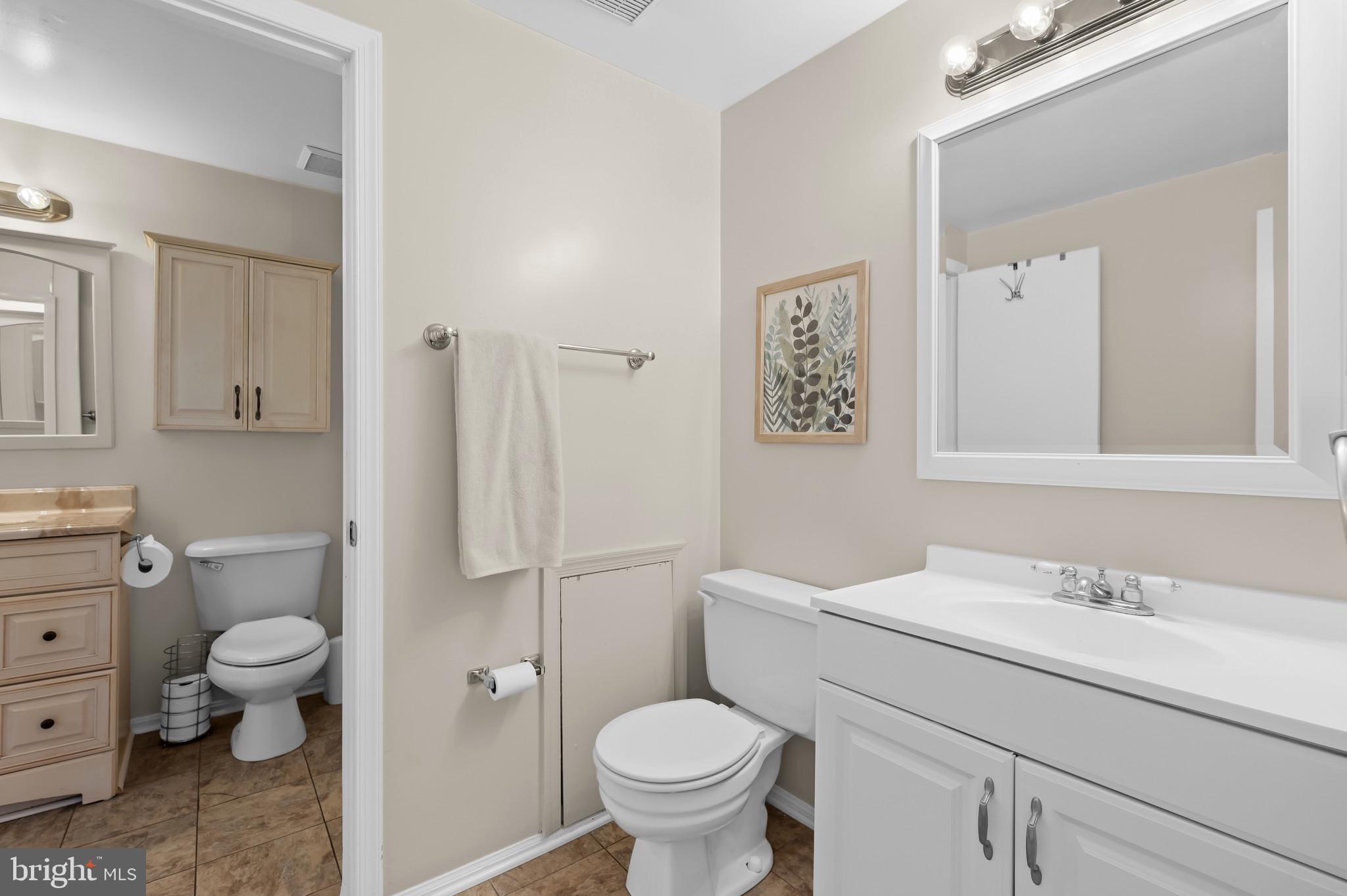 4511 Jenner Court Olney, MD 20832 - Photo 14 of 40 a bathroom with a toilet sink vanity and mirror