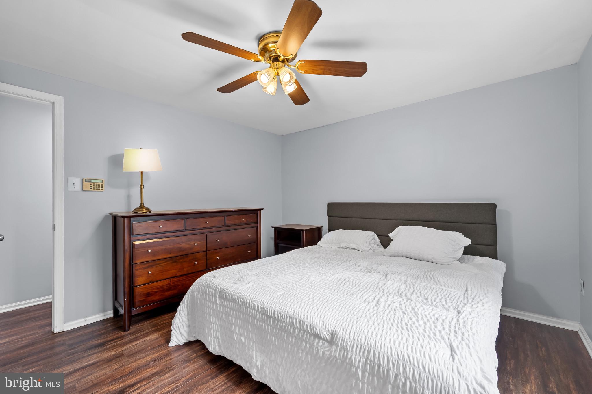 4511 Jenner Court Olney, MD 20832 - Photo 17 of 40 a bedroom with a bed and a chandelier