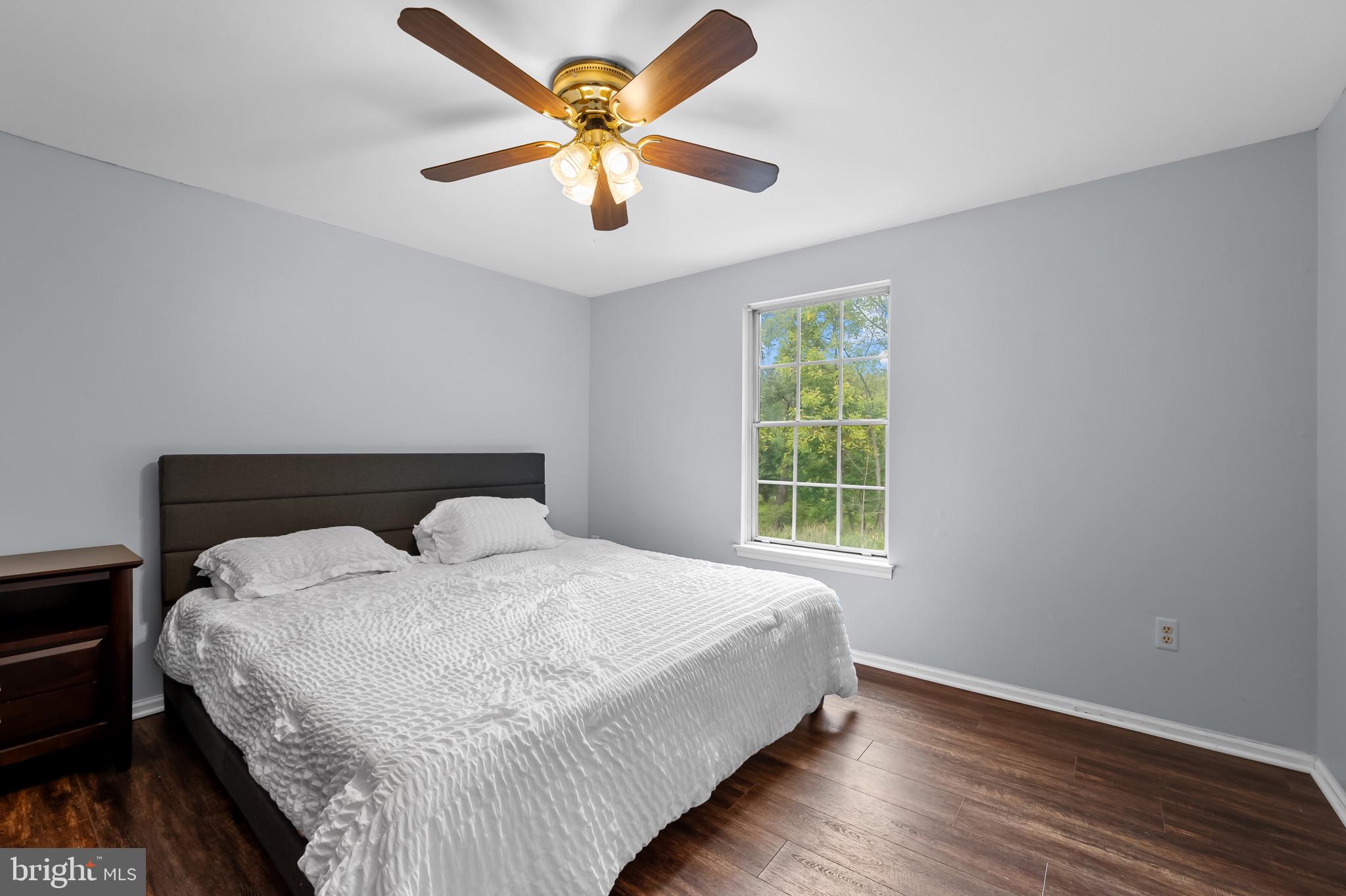 4511 Jenner Court Olney, MD 20832 - Photo 18 of 40 a large bed sitting in a bedroom next to a window