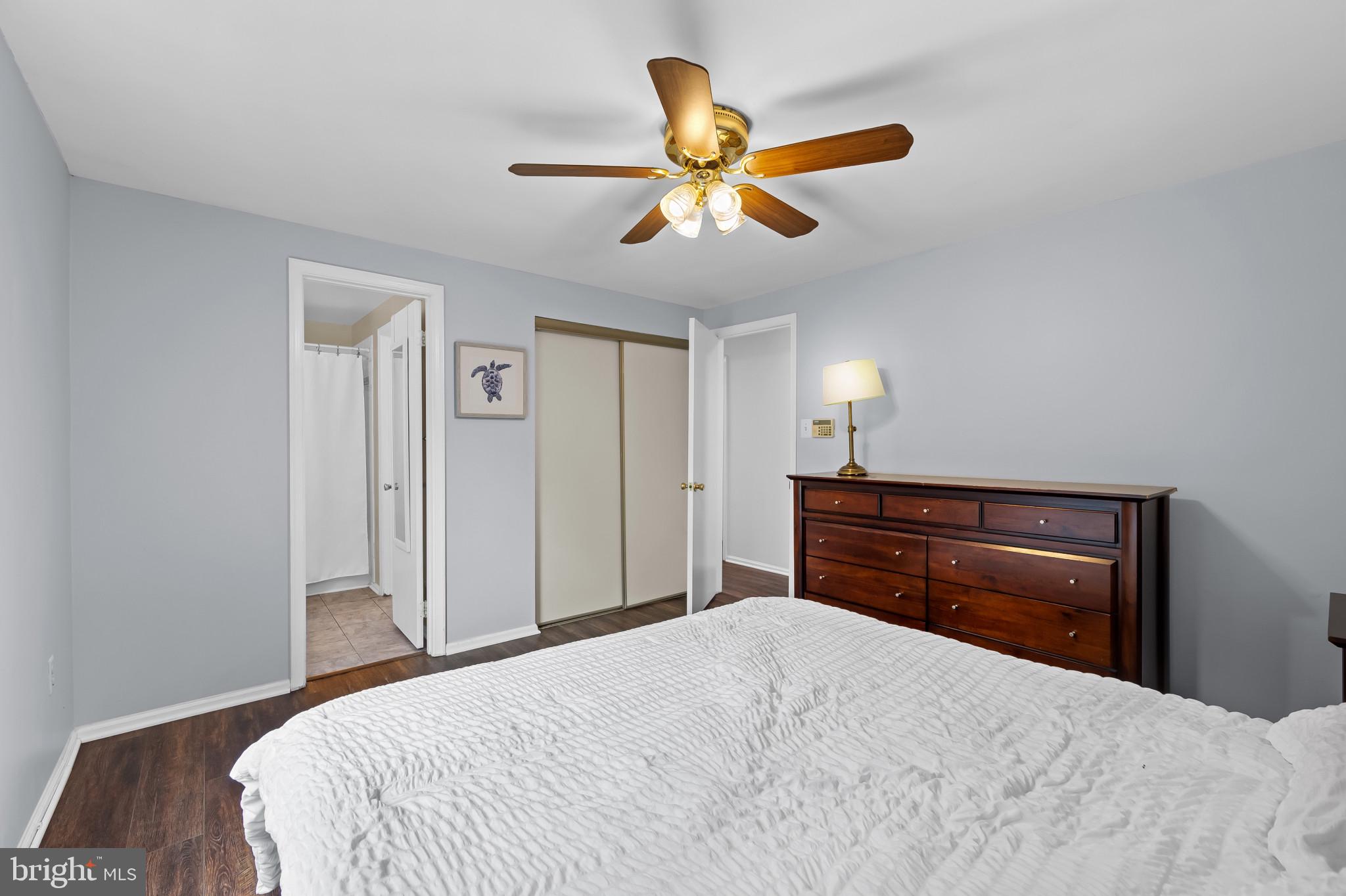 4511 Jenner Court Olney, MD 20832 - Photo 19 of 40 a bedroom with a bed and a chandelier