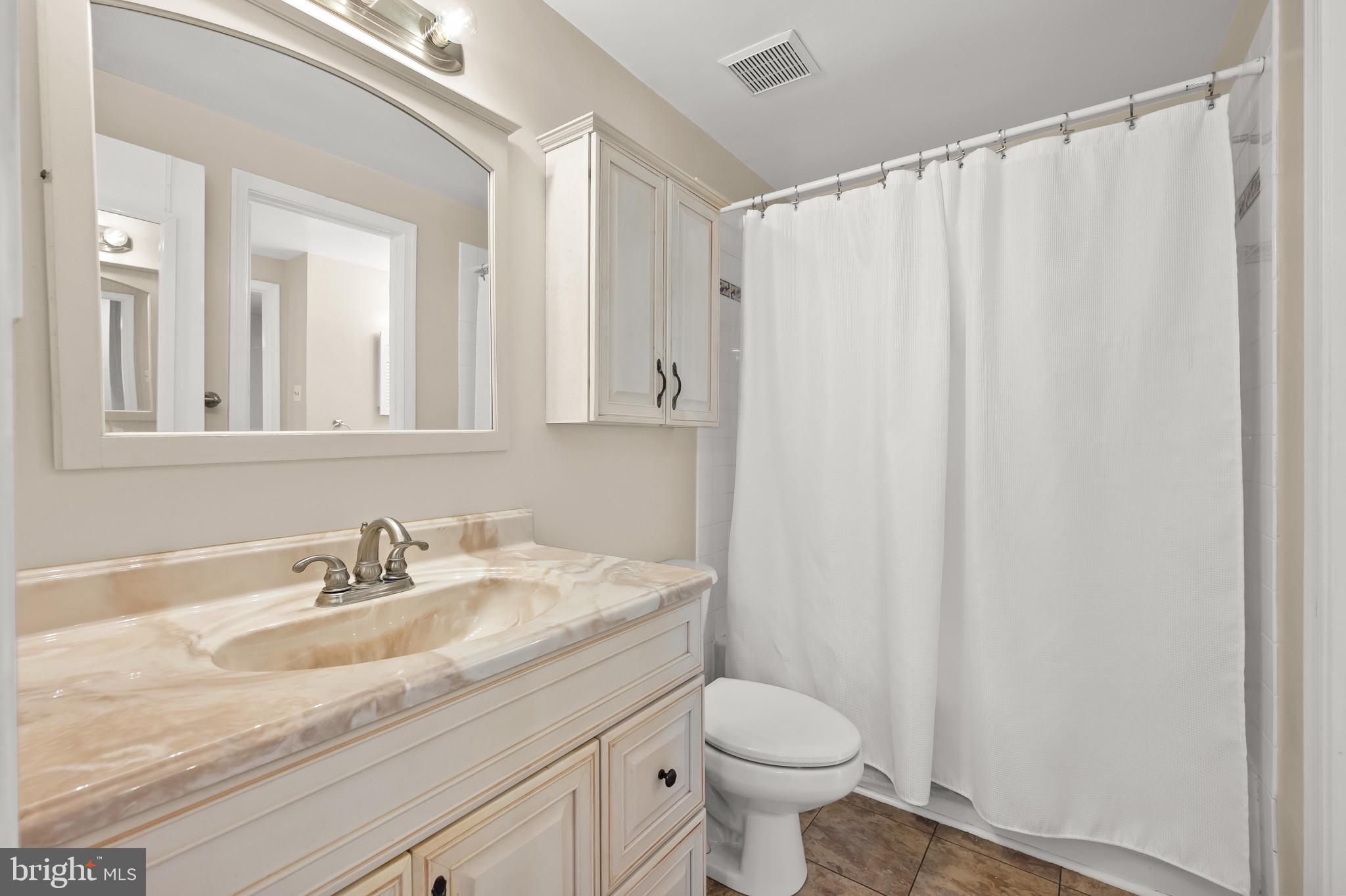 4511 Jenner Court Olney, MD 20832 - Photo 21 of 40 a bathroom with a granite countertop sink and a mirror