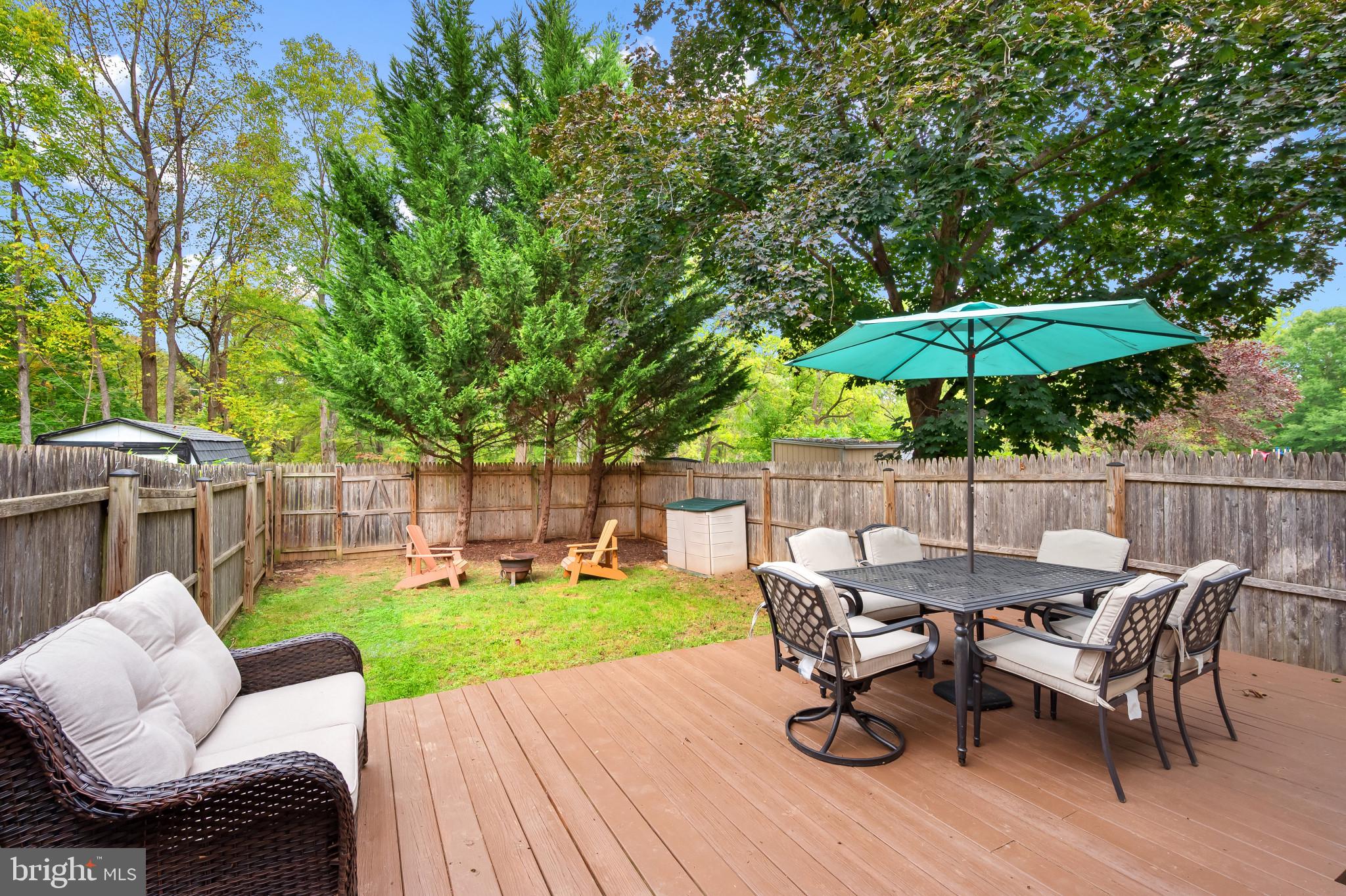4511 Jenner Court Olney, MD 20832 - Photo 35 of 40 a view of a table and chairs in patio with wooden fence