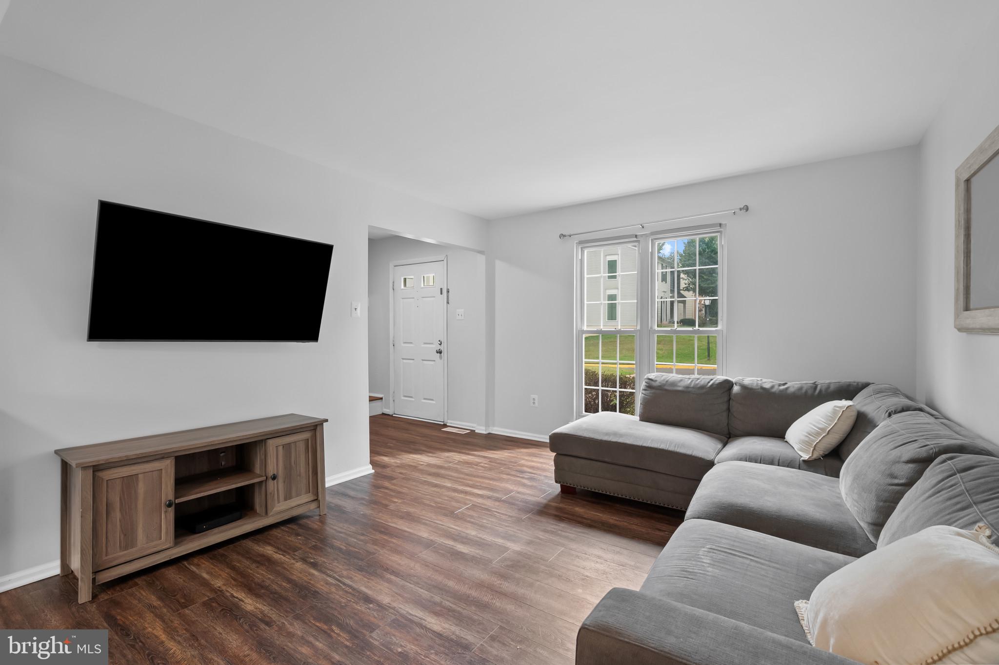 4511 Jenner Court Olney, MD 20832 - Photo 7 of 40 a living room with fireplace furniture and a flat screen tv