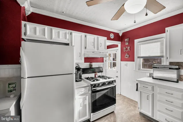a kitchen with stainless steel appliances granite countertop a refrigerator sink and stove