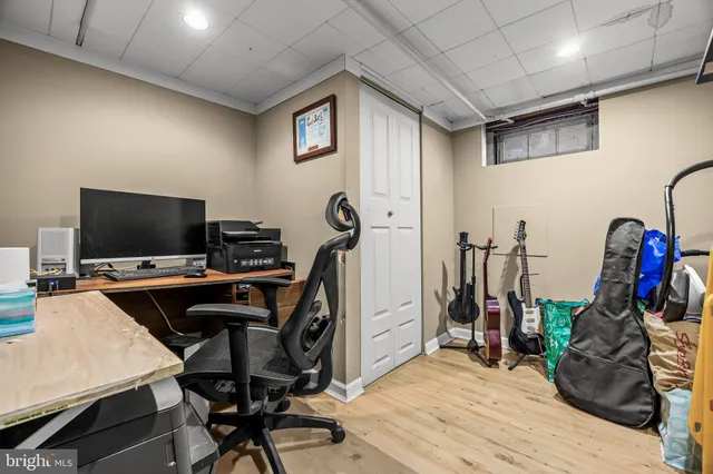 a view of a workspace with furniture and a flat screen tv
