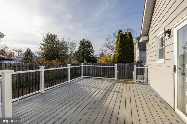 a view of balcony with wooden floor and fence