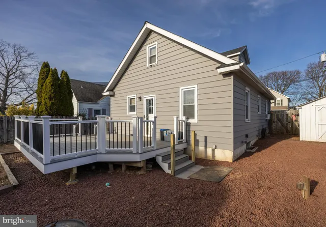 a view of a house with wooden fence