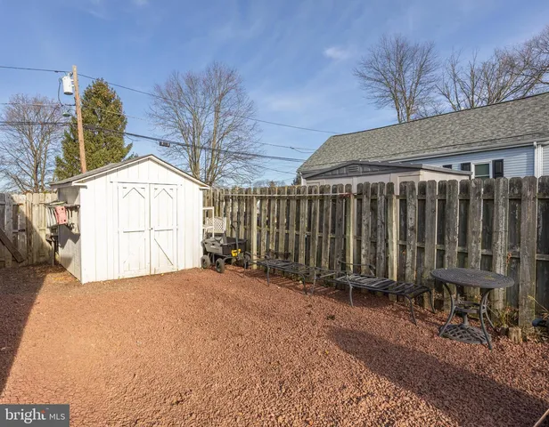 a view of backyard with tub and wooden fence