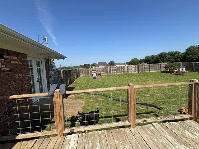 a view of a deck with a big yard