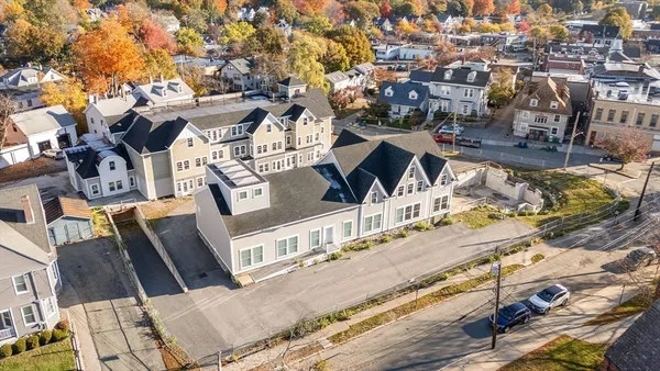 an aerial view of a house with a yard