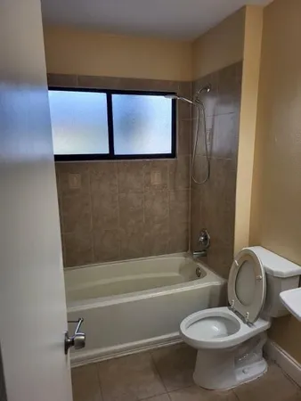 a bathroom with a toilet and a bathtub
