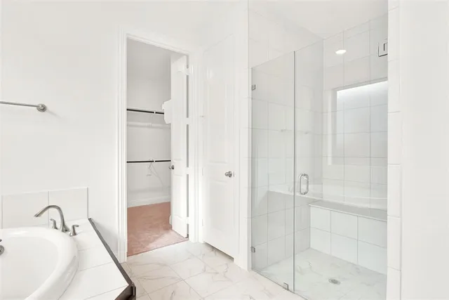 a bathroom with a bathtub and a shower