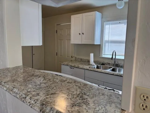 a kitchen with stainless steel appliances granite countertop a sink stove and cabinets
