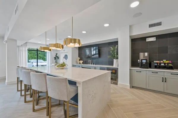 a large kitchen with a table and chairs