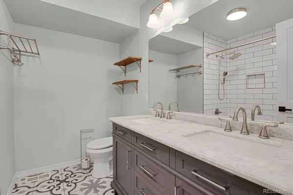 a bathroom with a sink a toilet and a mirror