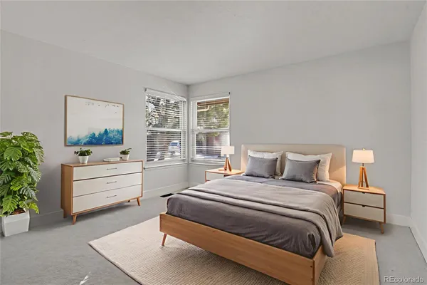 a bedroom with a bed and a potted plant