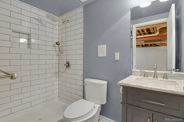 a bathroom with a toilet a sink a mirror and shower curtain