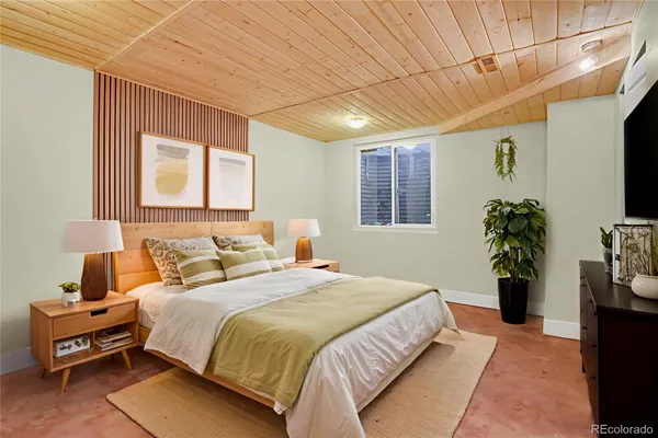 a bedroom with a bed and a potted plant