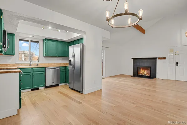 a view of a kitchen with a sink and a fireplace